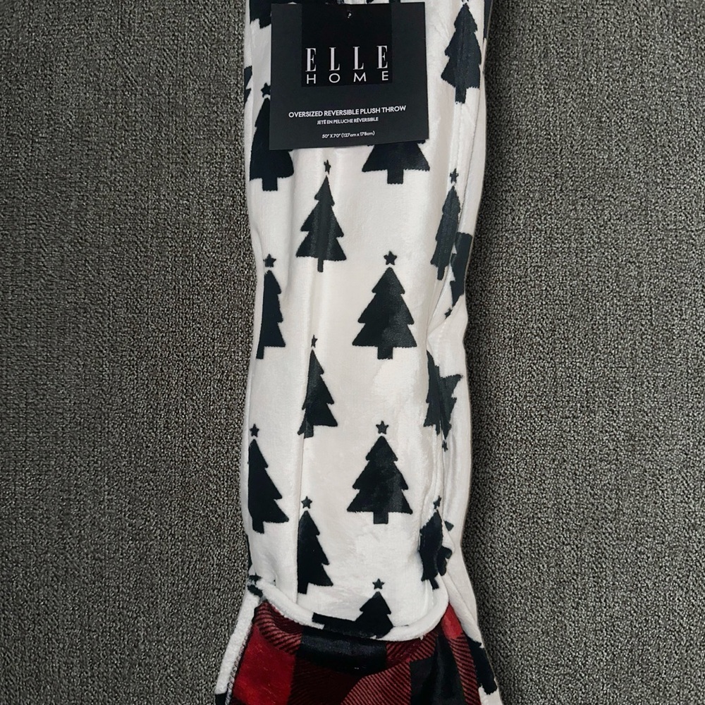 White blanket with black Christmas trees